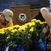 UM grounds employees remove flowers from the base of the stage after Spring Commencement on Saturday, May 4. The flowers will be donated to the veterans hospital. Daniel Brenner I AnnArbor.com